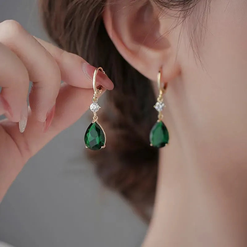 Green geometric teardrop alloy earrings on a white background