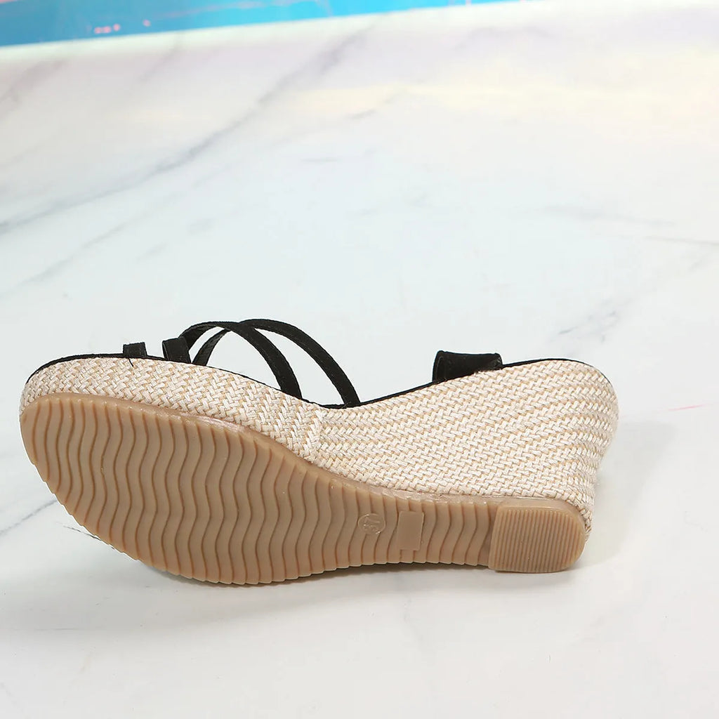 Women's black wedge sandals with cloth upper and fish-mouth toe design on a simple background.