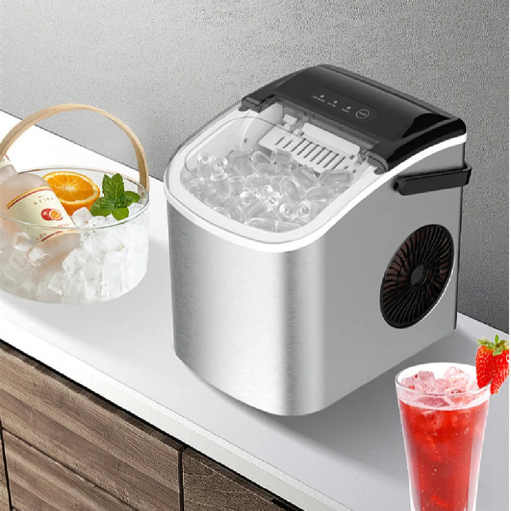 Silver countertop home ice machine with 1.2L capacity and push-button control on a kitchen counter