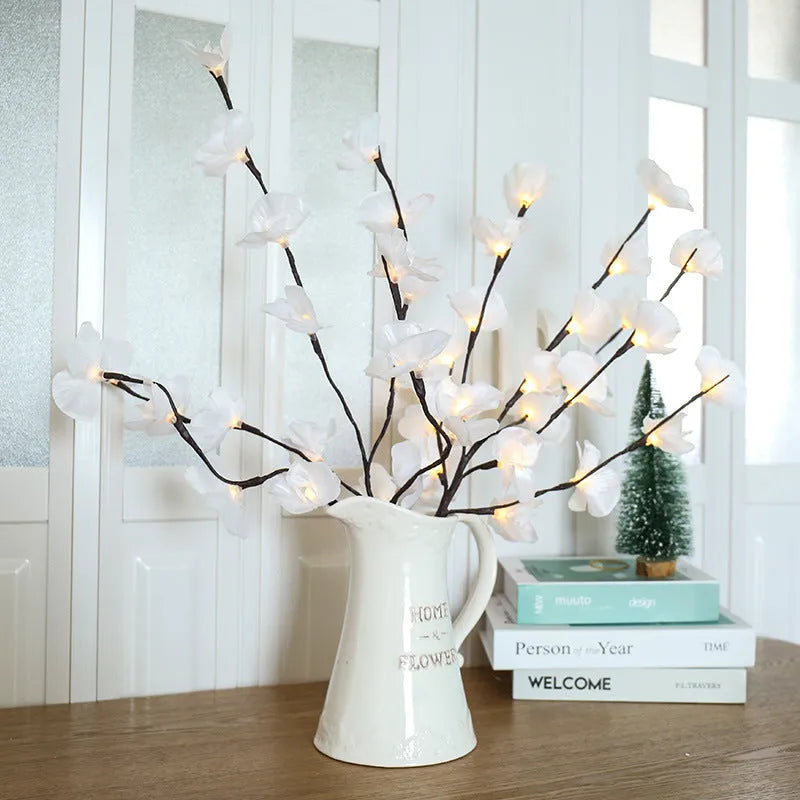 Pink LED phalaenopsis orchid branch decorative light on a table.