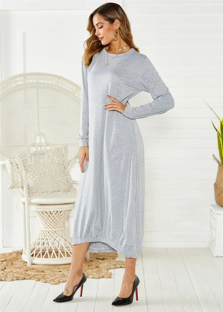 Loose black lantern dress with lace-up crew neck and threads detailing on a mannequin