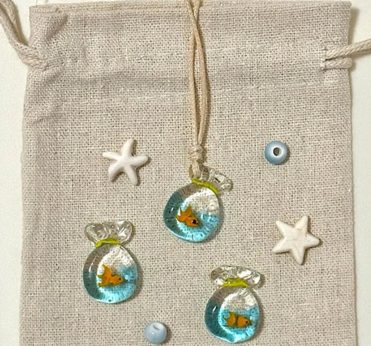 Women's joker pendant necklace with coloured glaze charm on a cotton and linen clavicle chain.