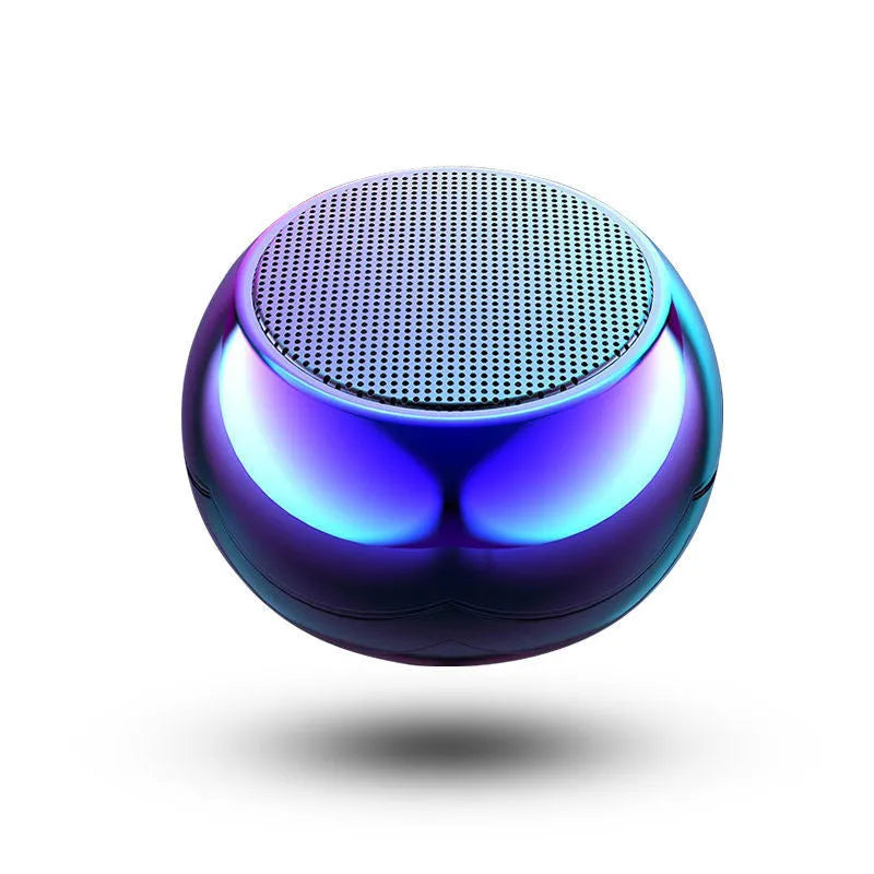 Small silver aluminium Bluetooth speaker showing USB port and compact size
