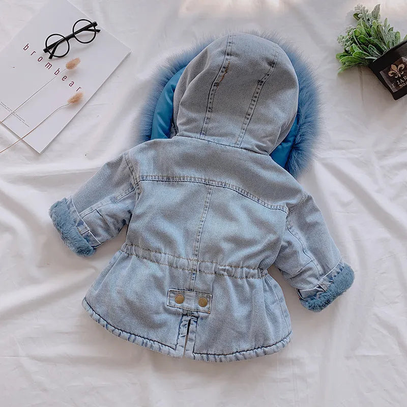 Blue girls' denim coat with a non-removable hood and fleece lining, shown on a hanger.