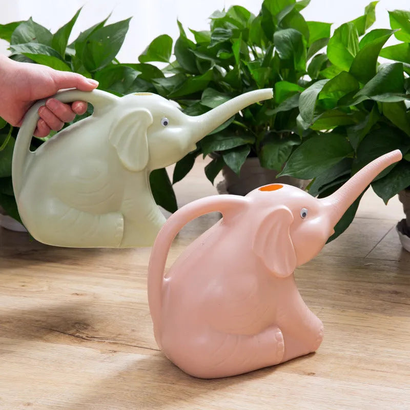 Pink plastic elephant-shaped watering can with a long nozzle and a child-sized handle.