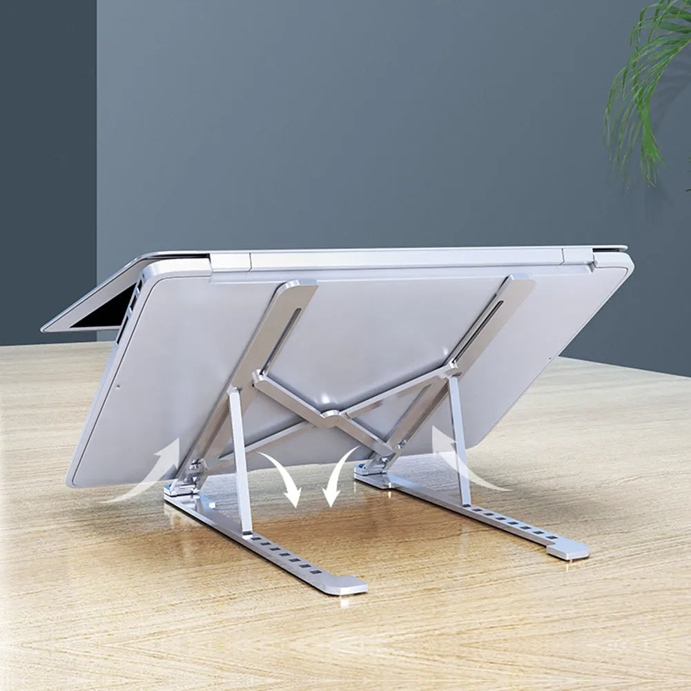 Aluminium foldable laptop stand in silver colour, shown elevated with a laptop on top