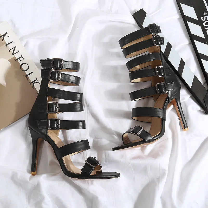 Women's high tube belt buckle high heel sandals in black with Roman boot style and ankle strap