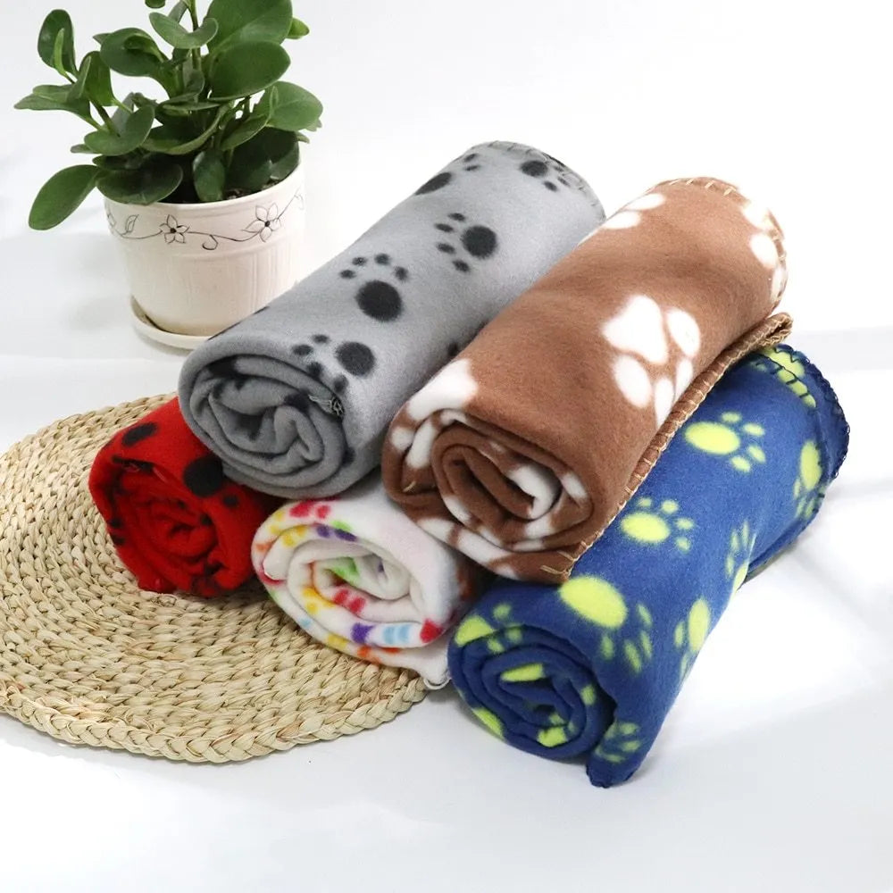 Pet warm blanket with paw print design double-sided fleece in blue colour, laid flat on a surface