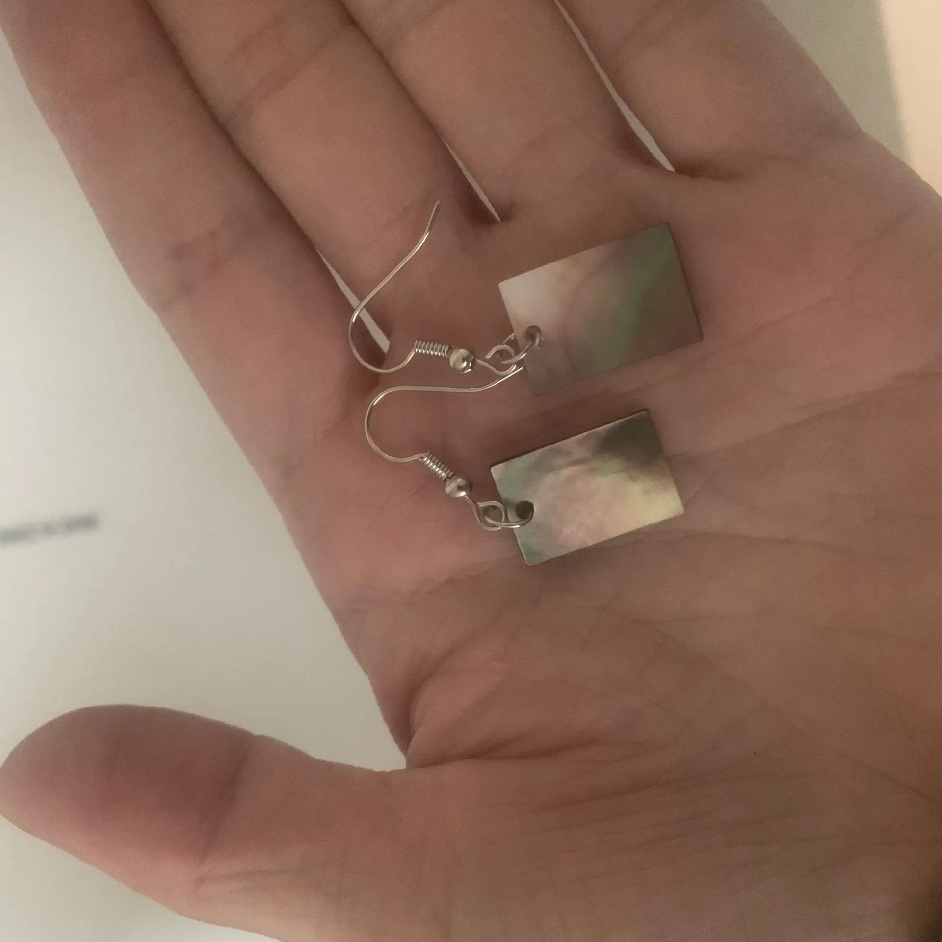 Women's geometric shell earrings showing rectangular and square shapes with natural shell material texture