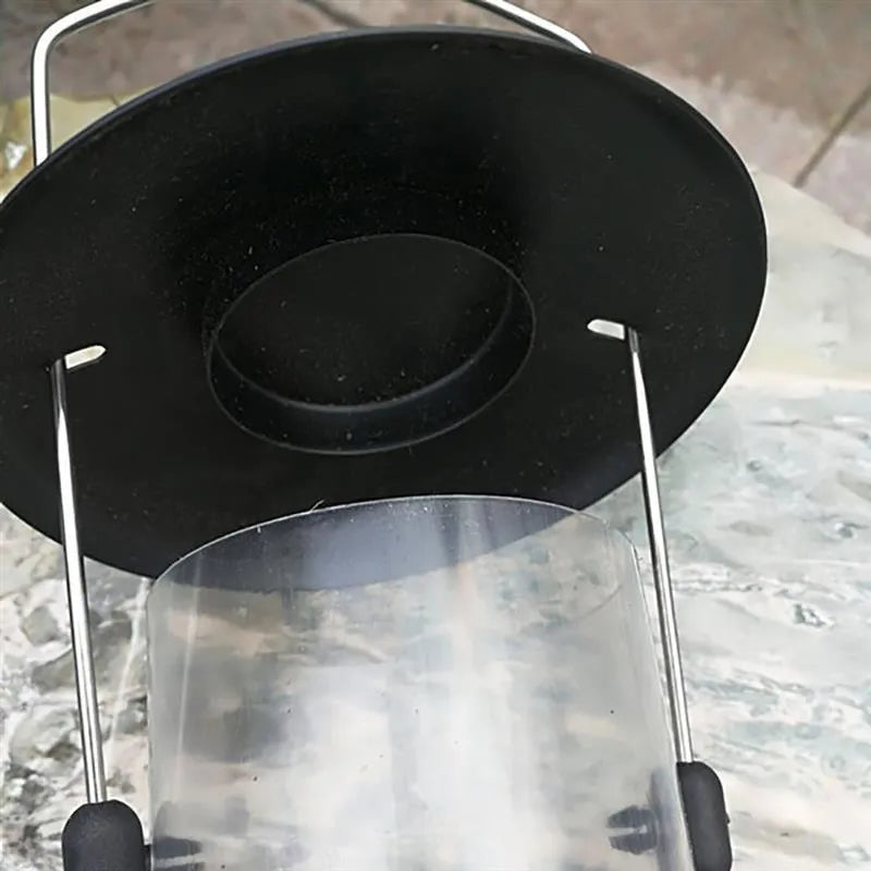 Black hanging bird feeder with transparent case, metal top and bottom, side feeding holes, and top hanging ring, 21.5x11x13cm