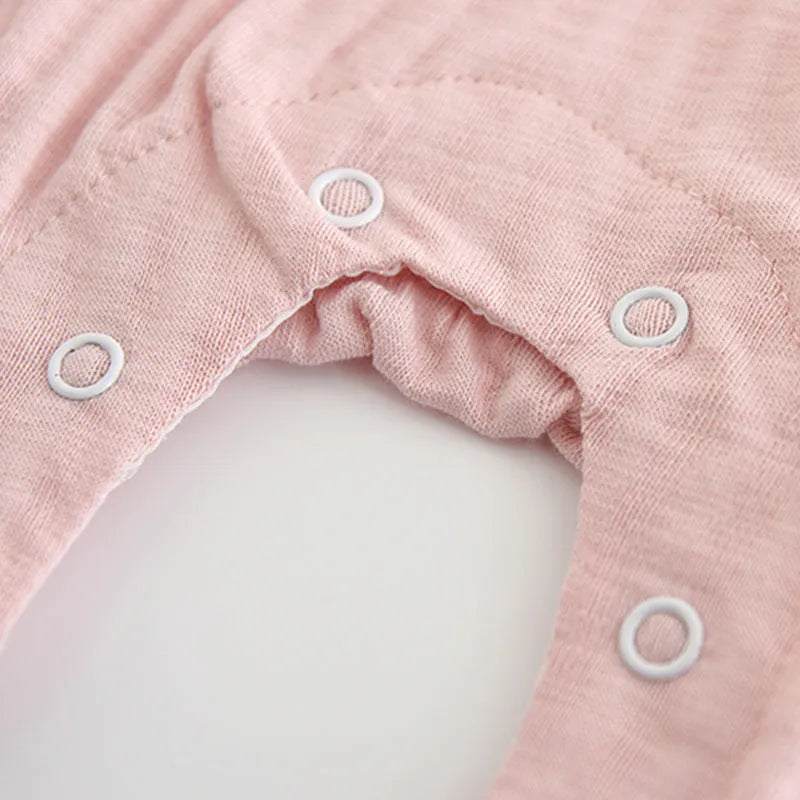 Pink baby girls embroidered jumpsuit with long sleeves and a single-breasted closure.