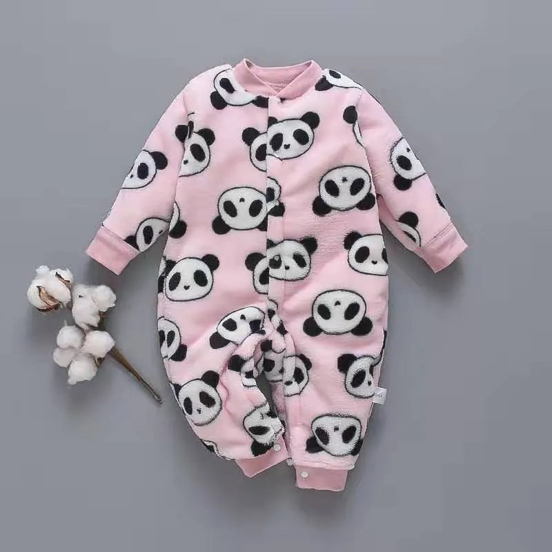 Baby wearing a long-sleeved flannel romper in a pink bunny head print, showcasing the 100% cotton fabric.