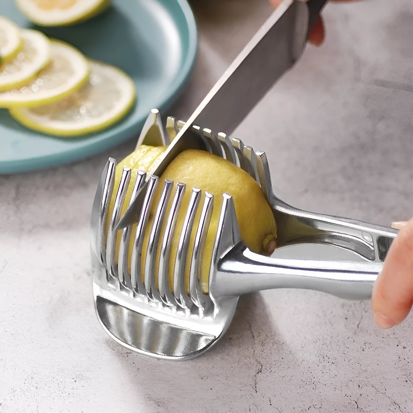 Silver plastic foldable lemon and fruit slicer kitchen gadget shown open for use