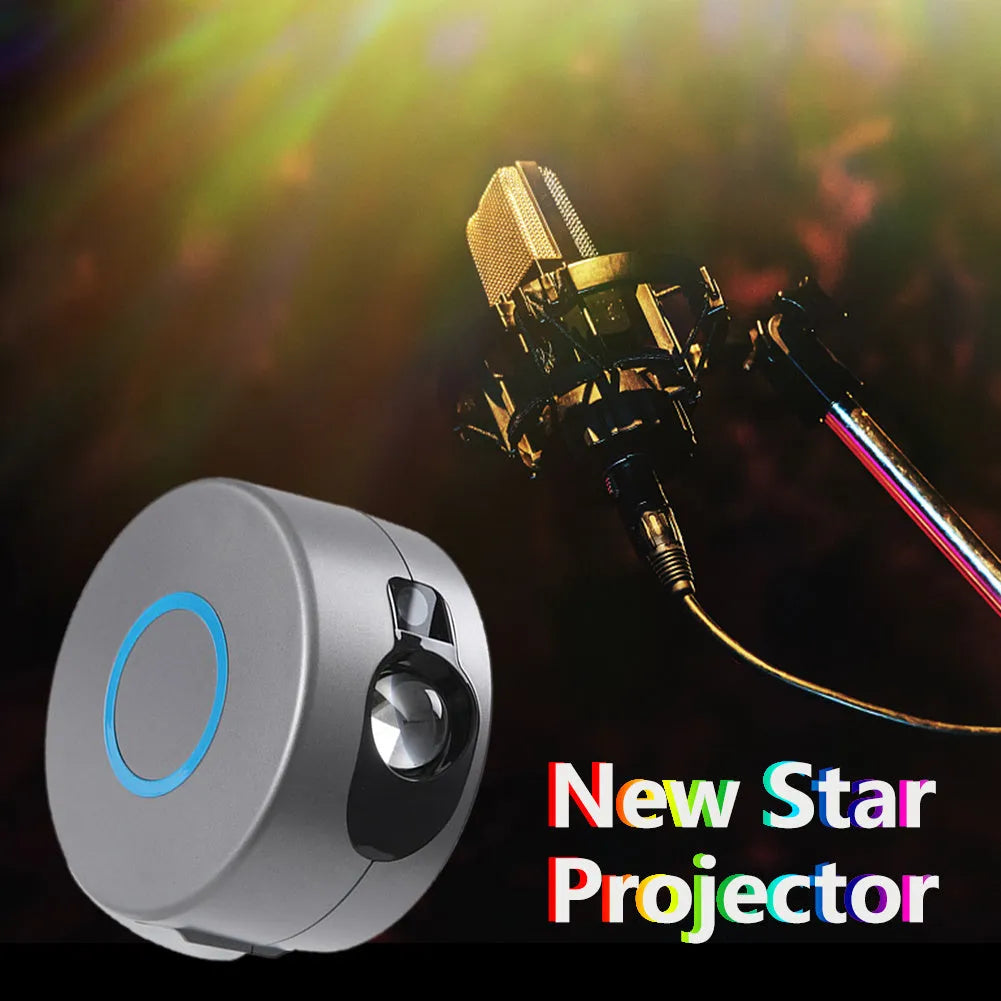 Grey starry sky projection lamp with remote control on a table, projecting colourful light dots on a dark wall.