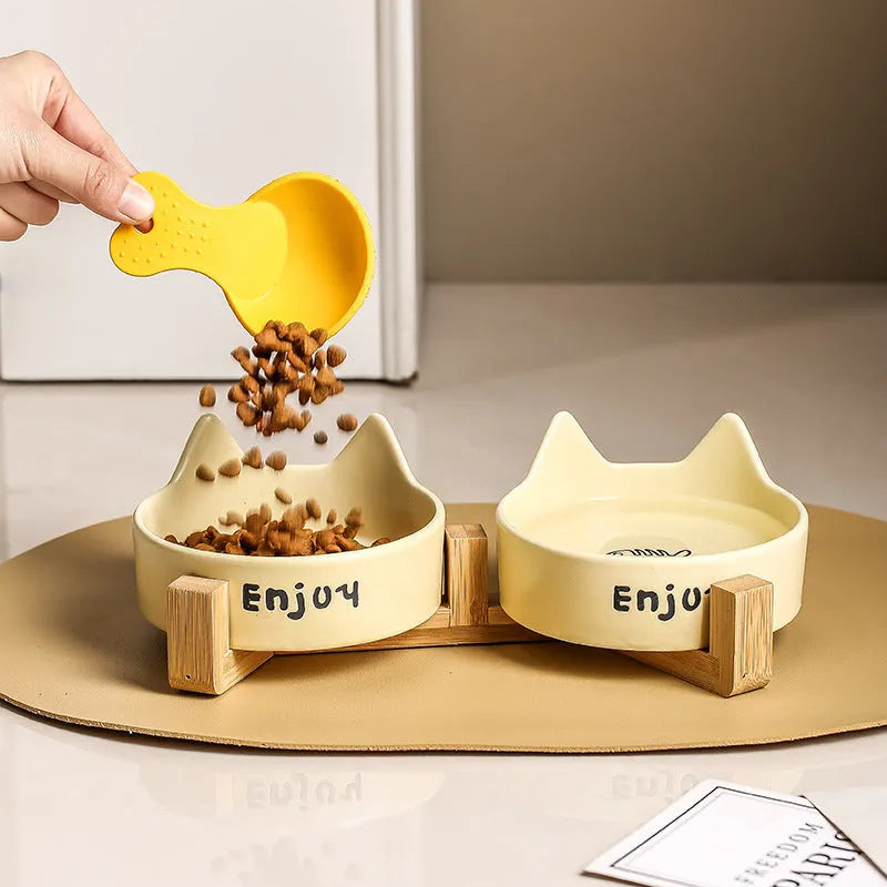 Porcelain cat food and water bowl set with wooden anti-slide frame in a choice of colours and patterns.