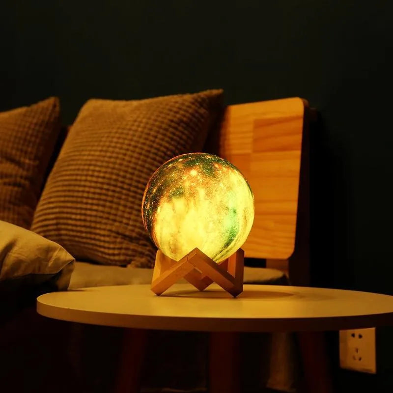 3D-printed white lunar sphere LED night light on a dark surface, showing touch and remote control.