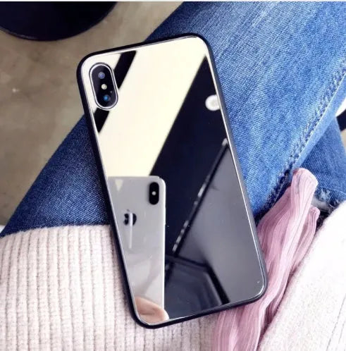 Black phone case for iPhone with a reflective mirror surface on the back.