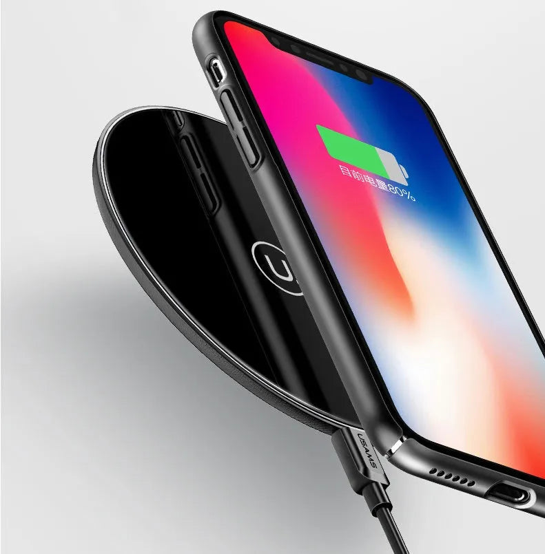 Black or white glass disc wireless charger on a surface, showing status light.