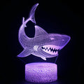 Shark shaped 3D LED table lamp with colourful lighting on a square black ABS base.