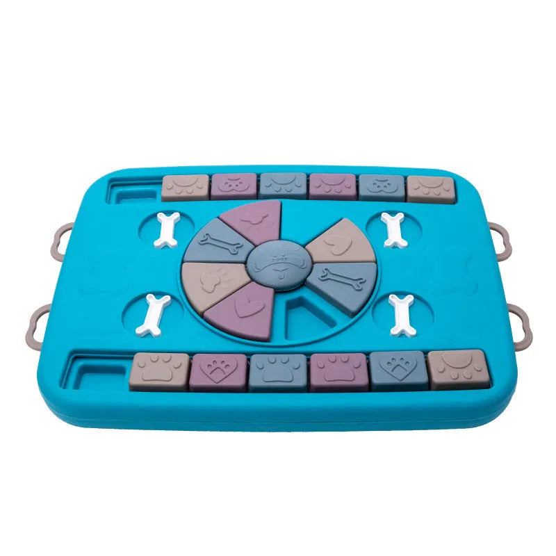 Blue plastic interactive dog puzzle feeder with sliding panel and four corner handles on a non-slip base