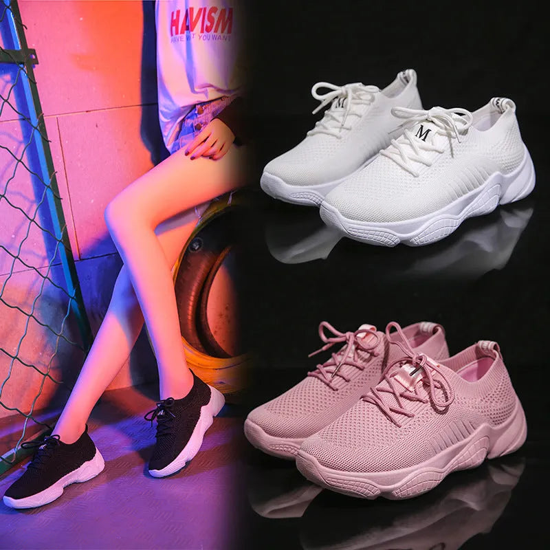 White thick-soled women's flyknit trainers with front strap and rubber sole.
