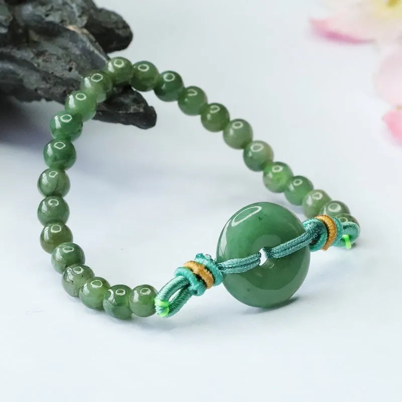 Natural emerald jade bracelet with star-shaped beads and a silver safety buckle.