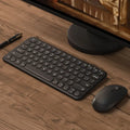 White ultra-thin wireless keyboard and mouse set on a desk, showing USB receivers and keyboard film.