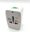Compact white universal travel plug adapter and charger converter on a grey background.