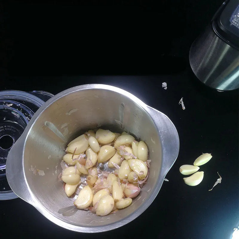 White electric garlic peeler appliance on a kitchen worktop.