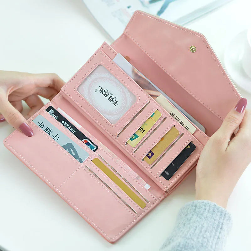 A folded black PU leather wallet with a buckle closure, showing multiple card slots and compartments inside.