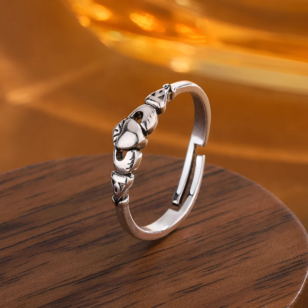 Retro silver women's open ring with a heart shape on a copper band.