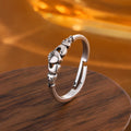 Retro silver women's open ring with a heart shape on a copper band.