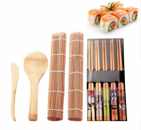 White sushi tool set with bamboo rolling mat, rice paddle, and sushi mold on a surface.