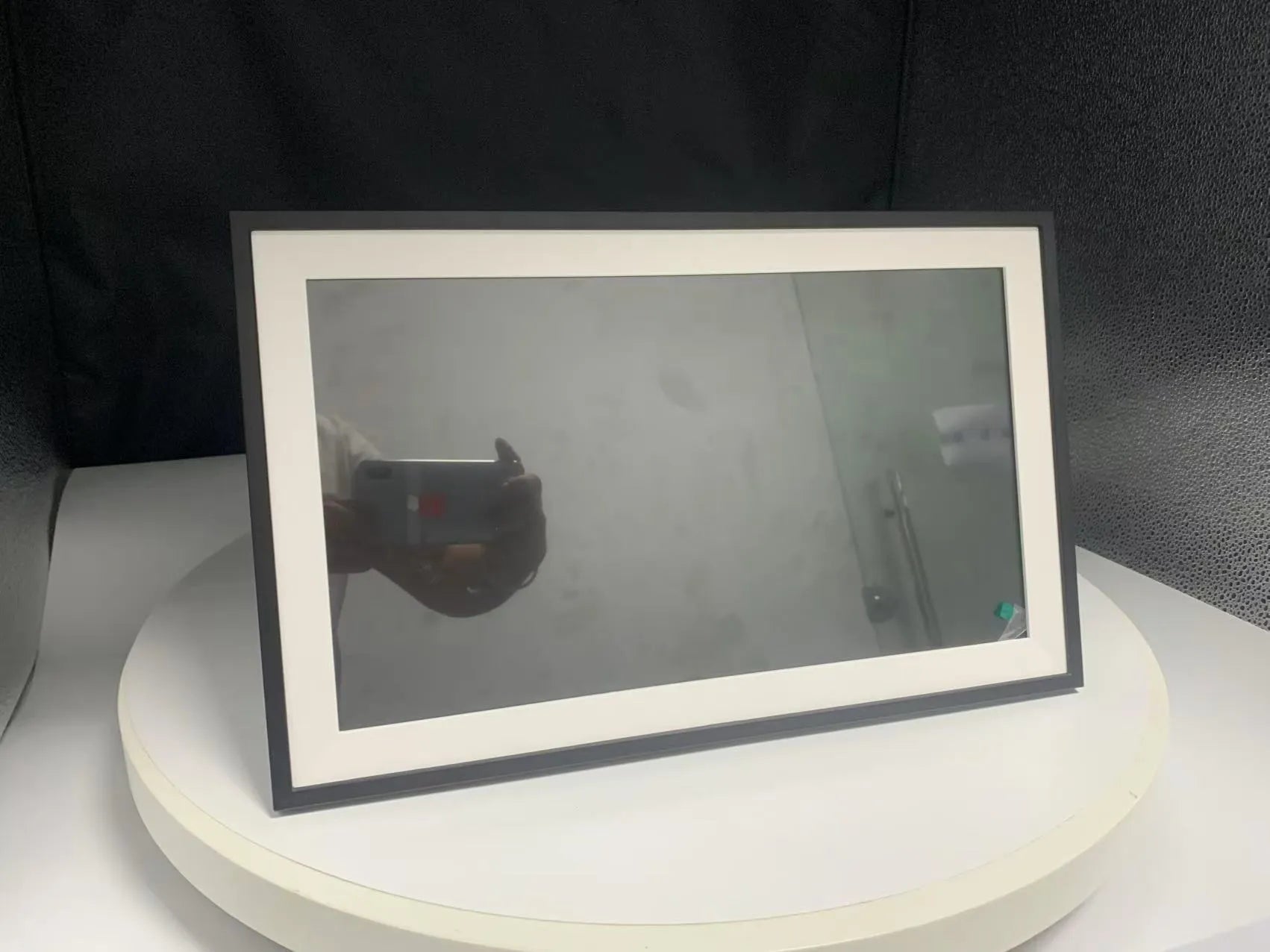 White smart digital photo frame with 15.6-inch screen and wall mount bracket