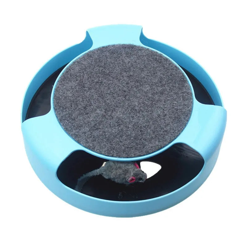 Blue rotating plastic cat toy with felt scratchpad on top standing on a floor