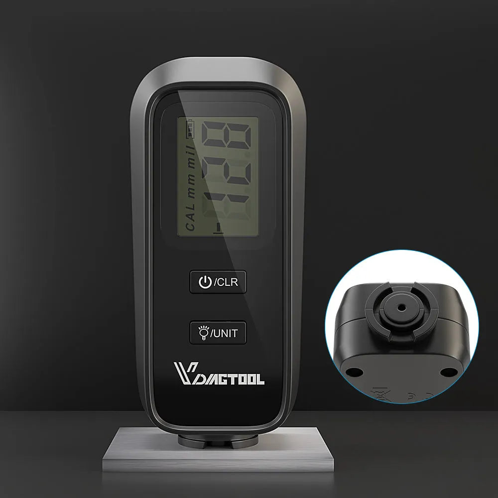 Black plastic automotive paint coating thickness gauge on white background