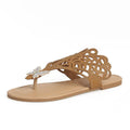 Women's black slip-on sandals with rhinestone decoration and a flip-toe, hollow design.