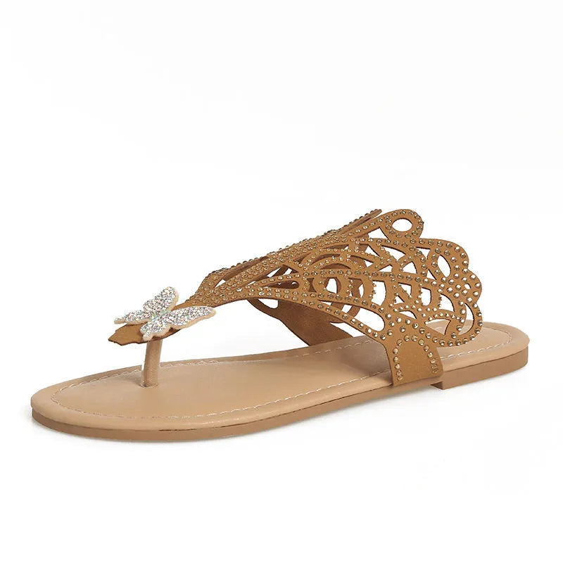 Women's black slip-on sandals with rhinestone decoration and a flip-toe, hollow design.