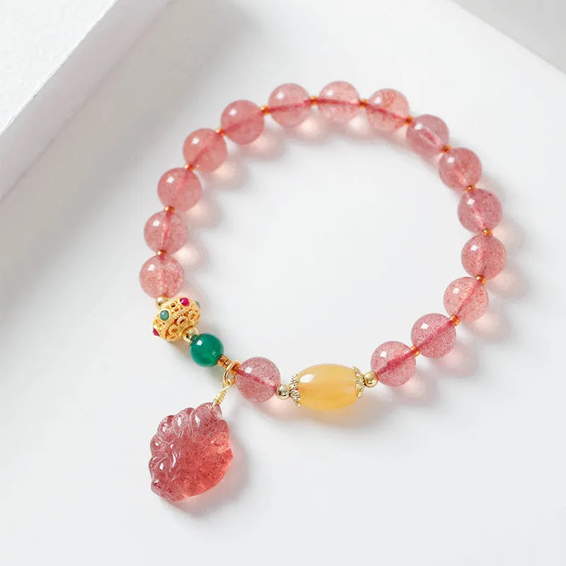 Women's crystal bracelet with nine tail fox design in polished natural strawberry quartz beads