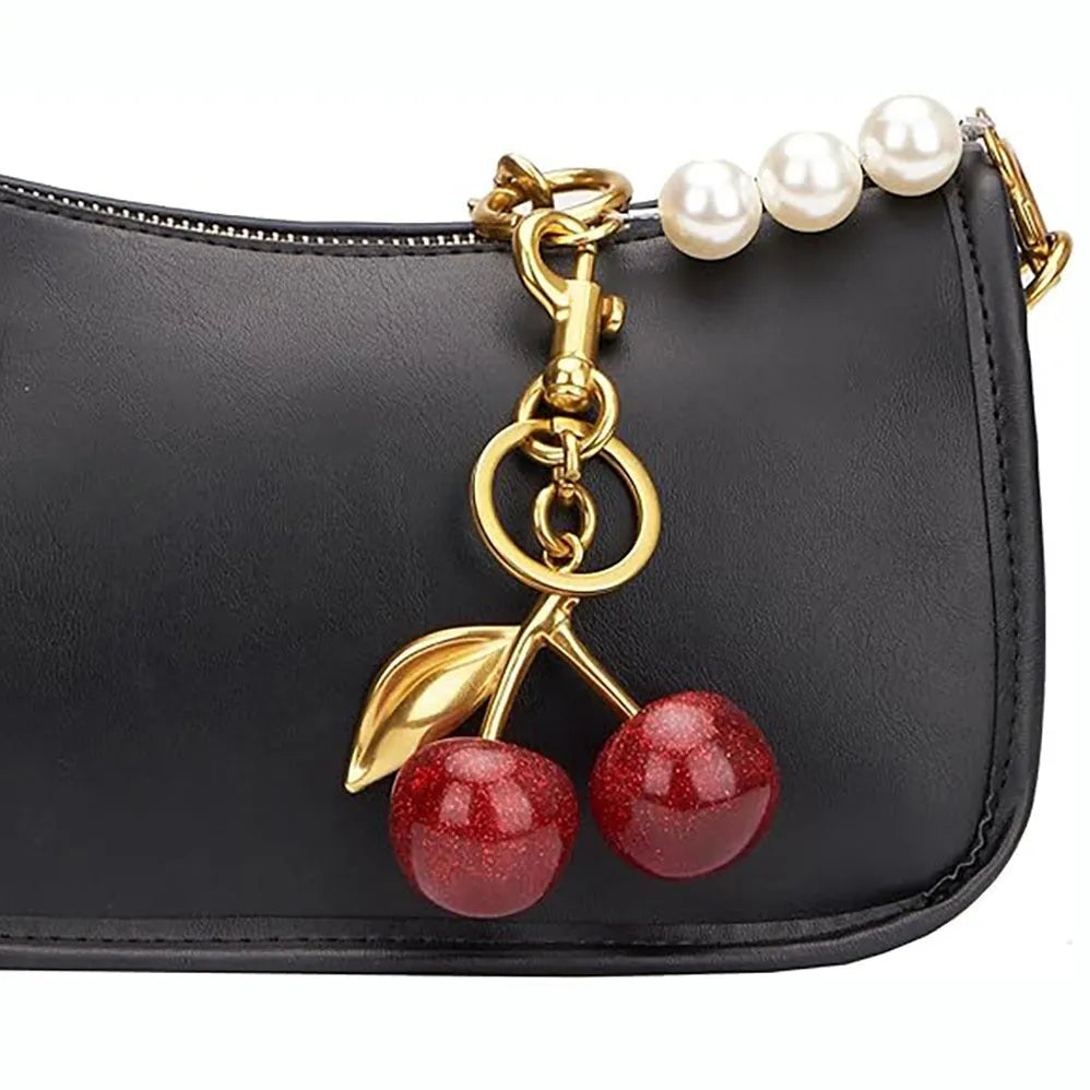 Red cherry-shaped zinc alloy keychain pendant with three-dimensional design on white background