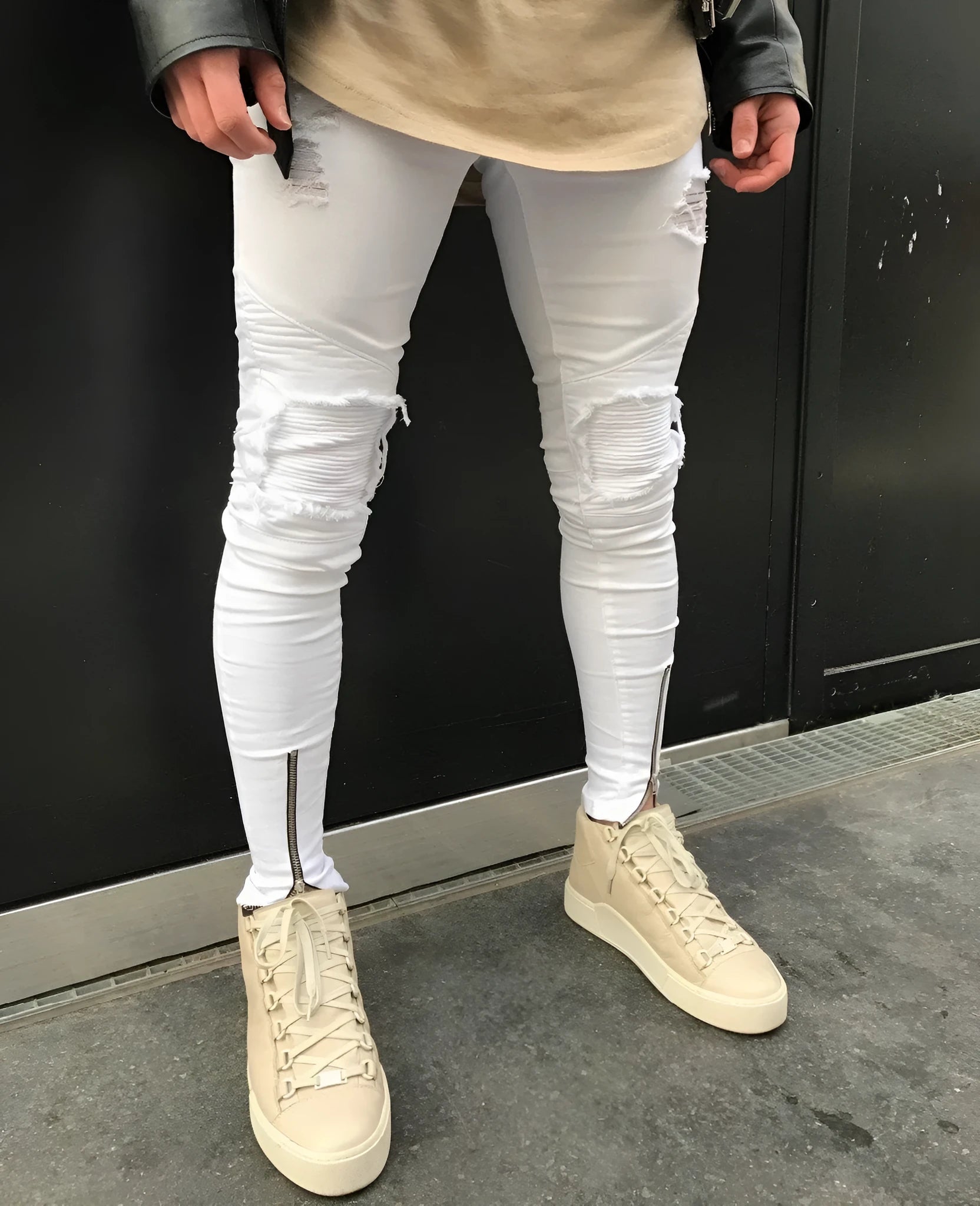 Ripped zipper jeans in black for women with stretch denim and multiple metal zippers on the legs