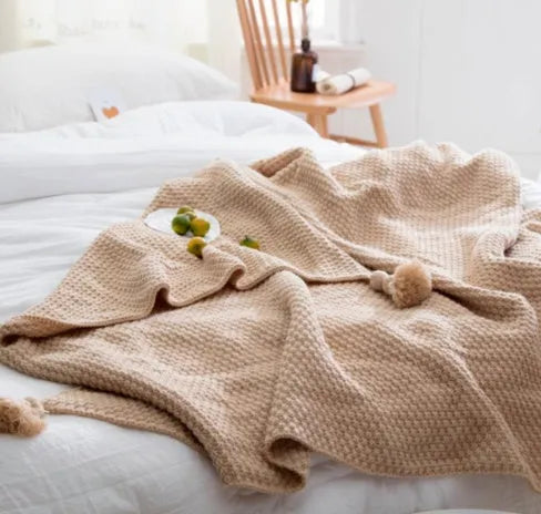 Nordic style fringed knit blanket in acrylic fabric, shown in beige colour, measuring 130 by 170 centimetres.