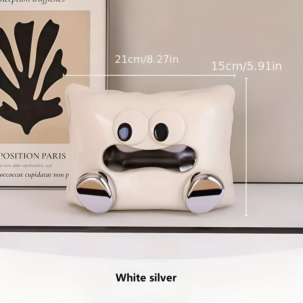 White glazed ceramic tissue box holder on a wooden coffee table.