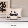 White glazed ceramic tissue box holder on a wooden coffee table.