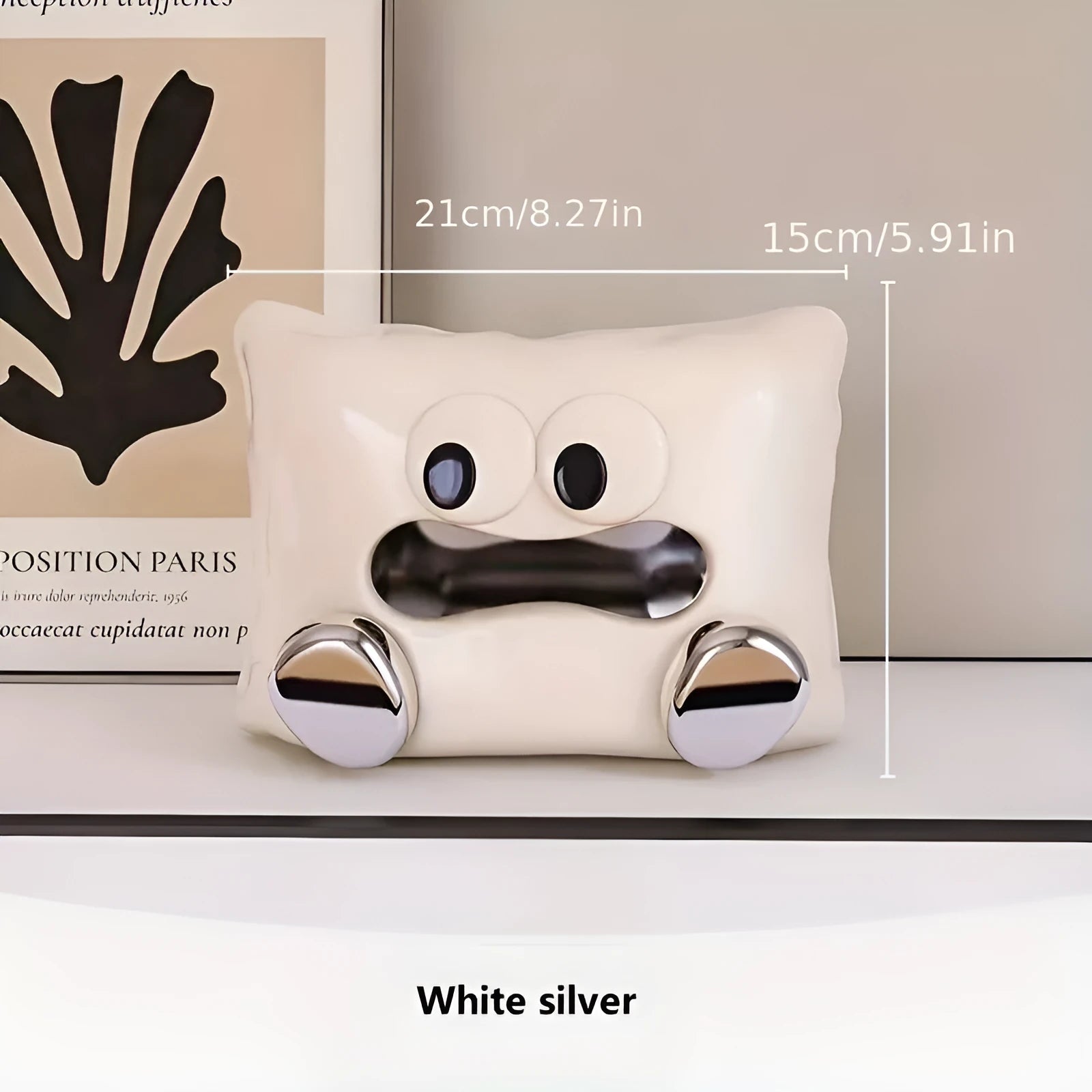 White glazed ceramic tissue box holder on a wooden coffee table.