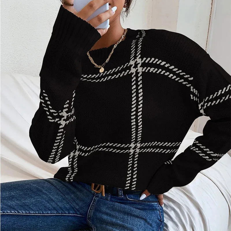 Women's loose-fit acrylic pullover sweater with a red, green, and beige plaid colour-block pattern.