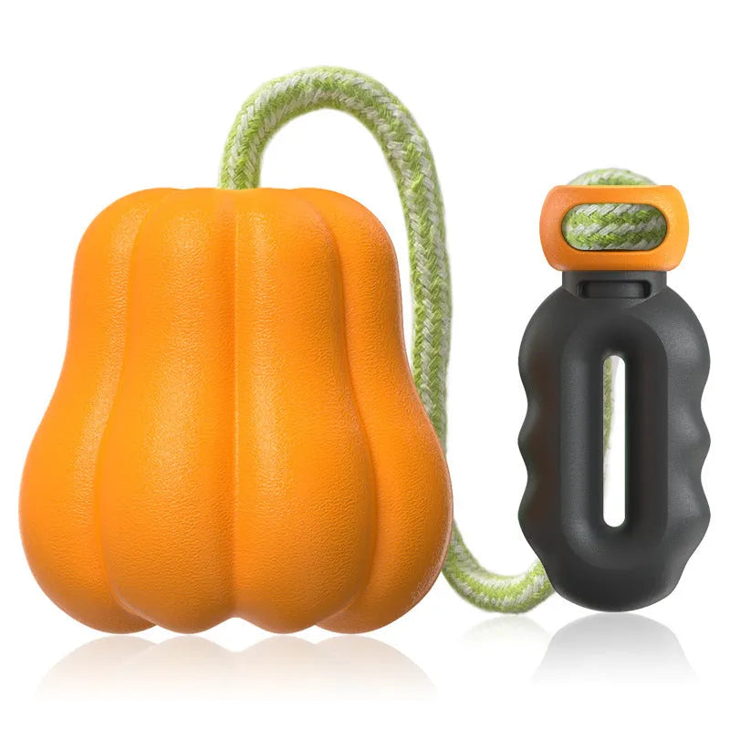 Pumpkin orange plastic dog chew toy with a woven rope handle for fetch.