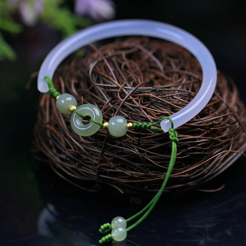 Hand-woven white agate bracelet with hetian jade accents and traditional peace buckle on wrist