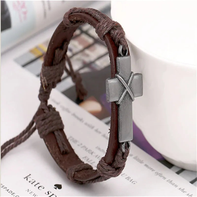 Brown leather cross bracelet with alloy accent, adjustable drawstring, vintage style on wrist