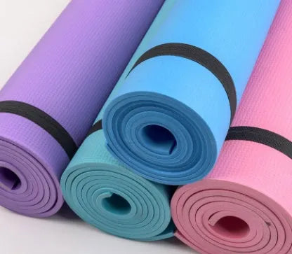 Red EVA fitness yoga mat rolled up next to its storage bag, showing textured surface.